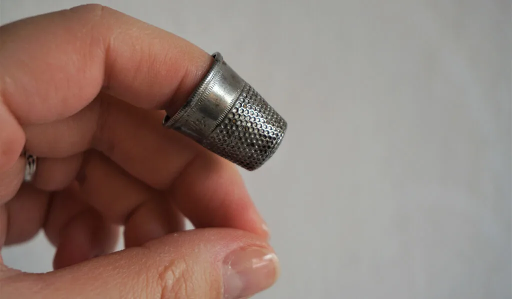 a thimble on a finger