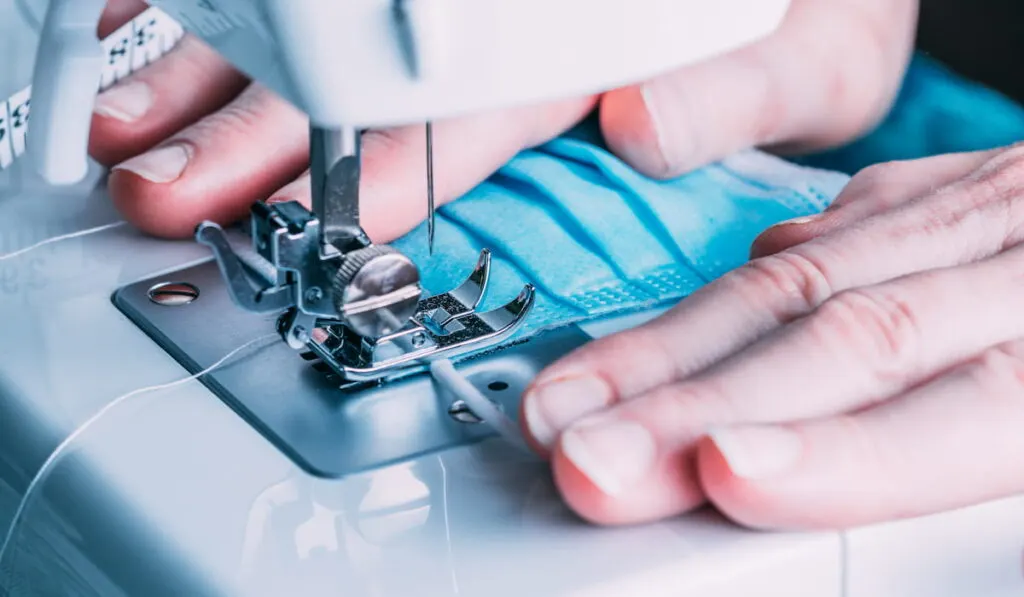 Woman sewing masks in the sewing machine