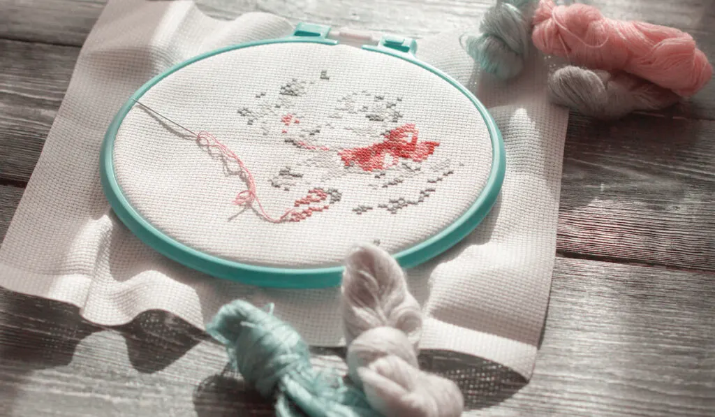 Cross stitch embroidery in progress in spring color