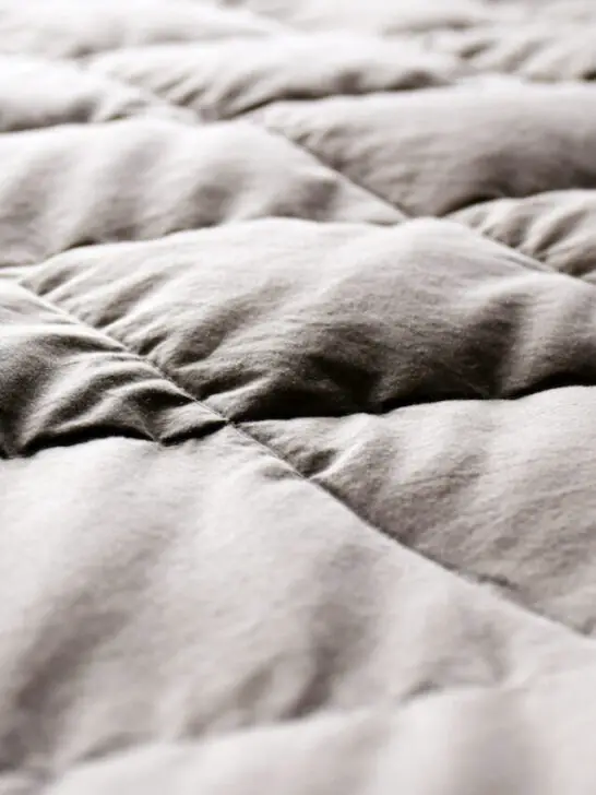 grey used quilt blanket