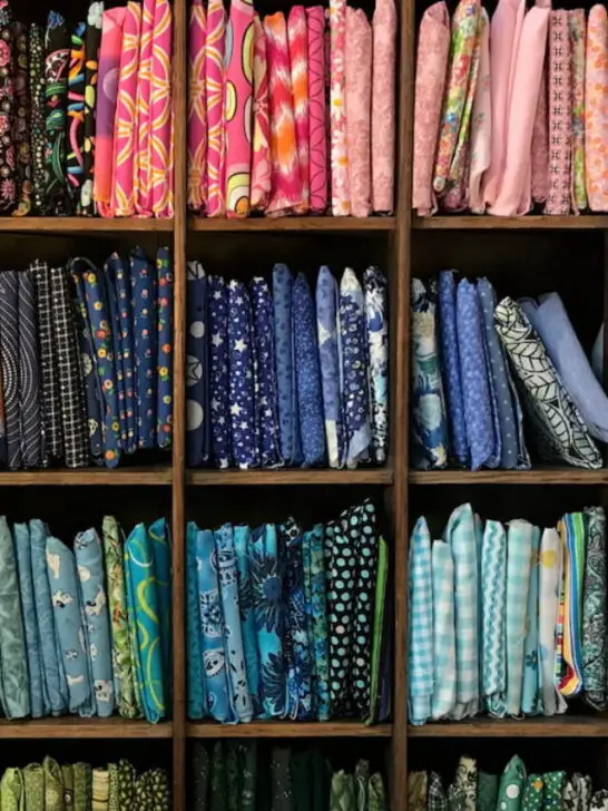 quilt fabrics inside wooden square shelves