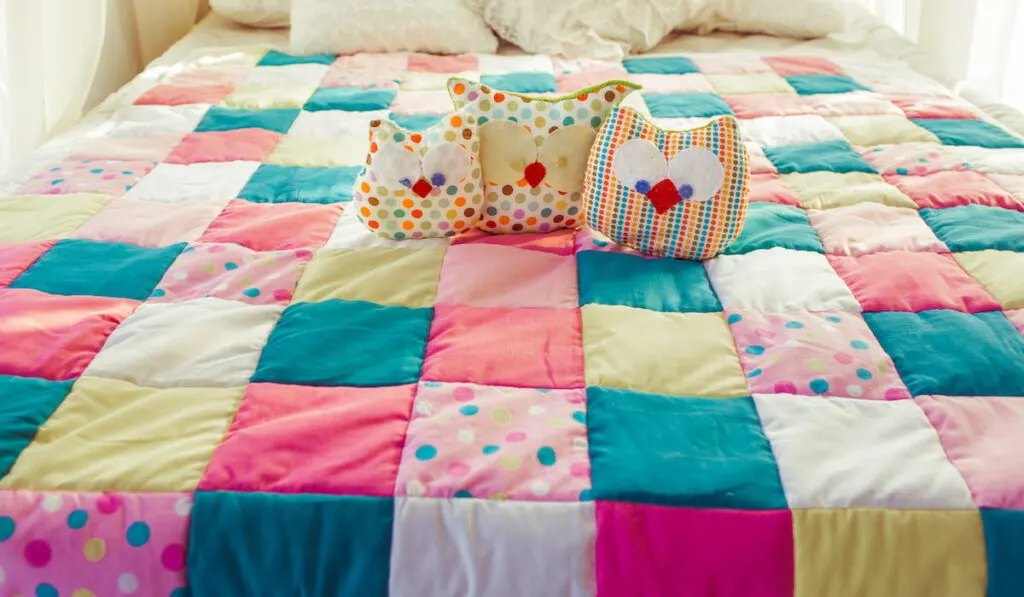 Colorful quilt on the bed 