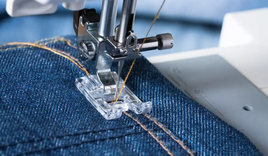 Foot Of Sewing Machine On Jeans Fabric