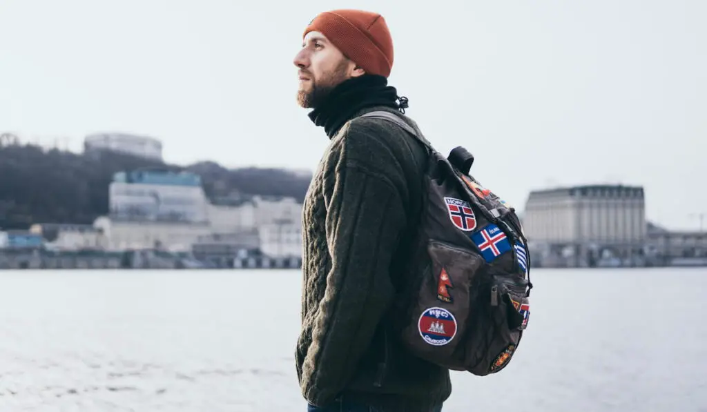 traveller with patches on backpack