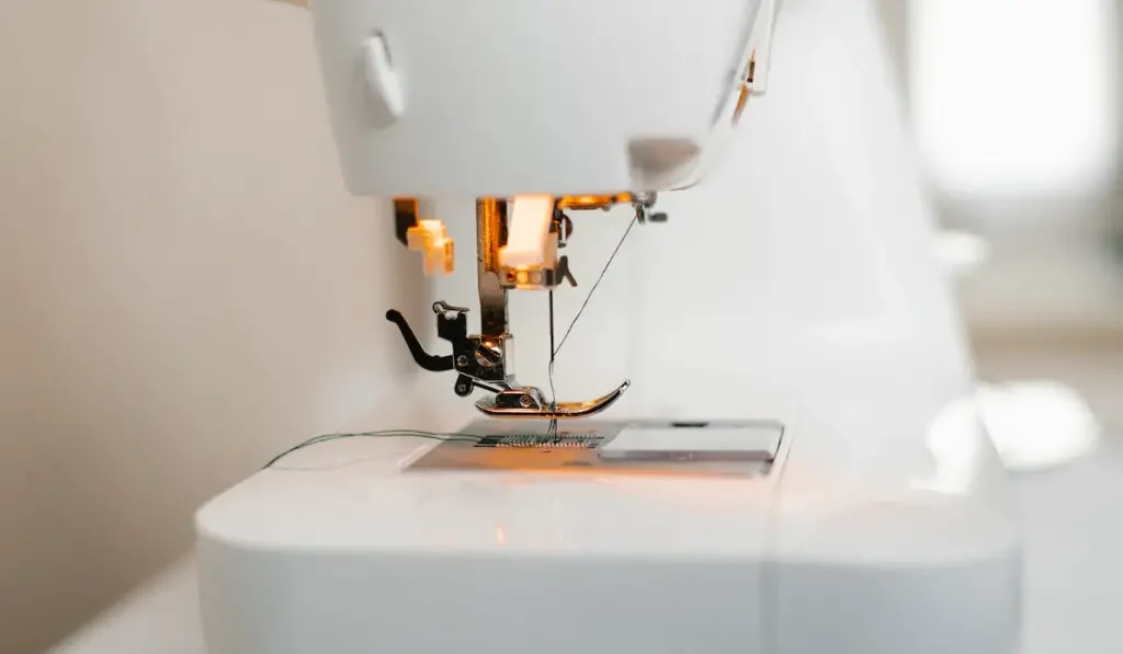 Close-up of a sewing machine with a needle and thread
