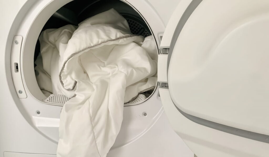  blanket or linen is pulled out of the dryer or washing machine