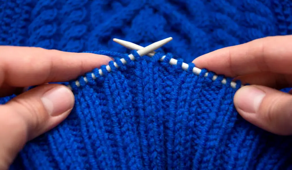 knitting a blue sweater