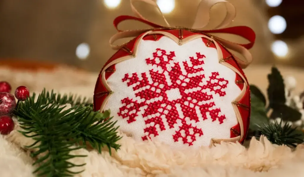 Embroidered Christmas ball with traditional folk pattern