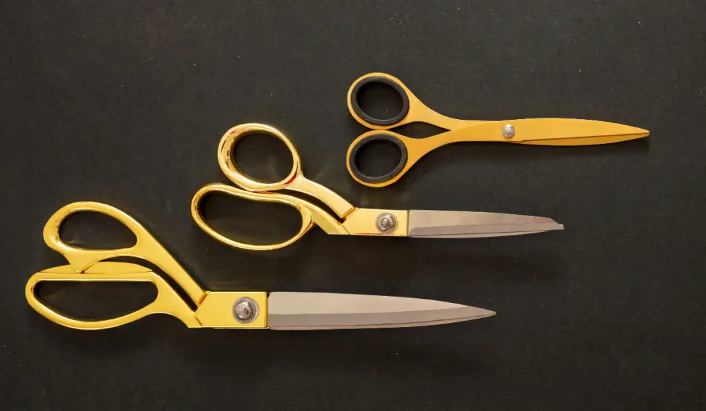 Scissors gold color set on black background