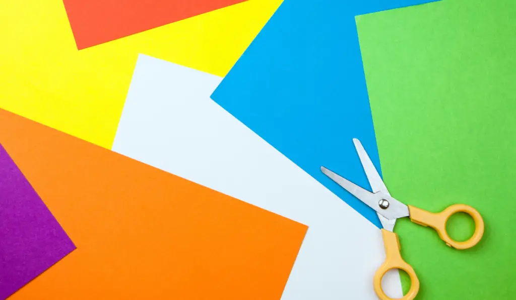 Colorful paper background with scissors
