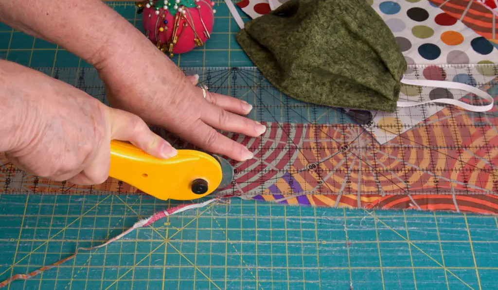 Woman's hands using a rotary cutter