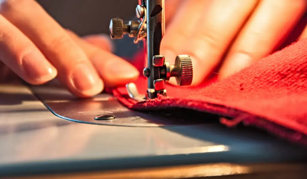 Women's hands behind her sewing