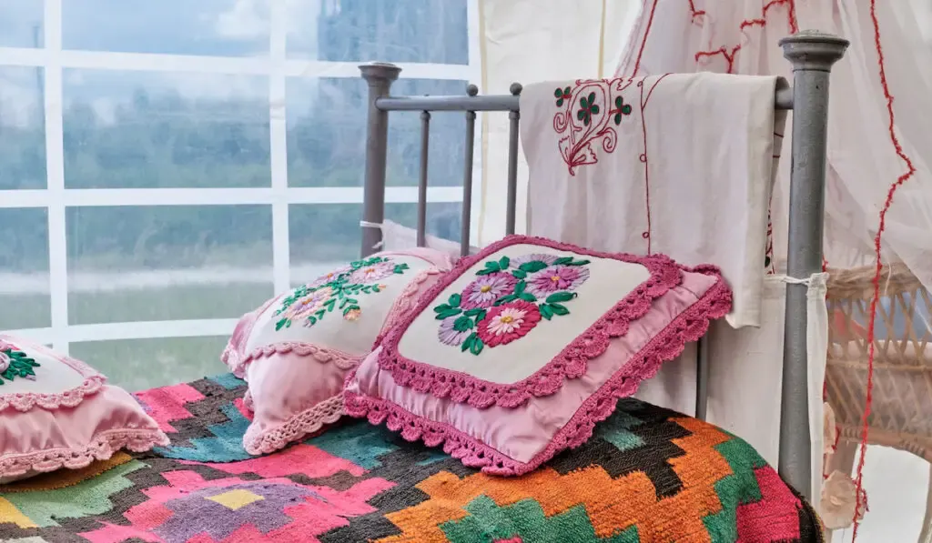 mall pillows decorated with embroidery ribbons with floral pattern and braid